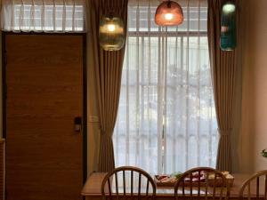 a dining room with a table and chairs and a window at Eiko的樓仔厝 台南包棟民宿 in Ching-chung-san-ts'un +27 photos
