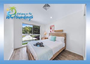 Postel nebo postele na pokoji v ubytování Blue Lagoon Airlie Beach