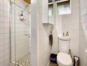 ein weißes Badezimmer mit Toilette und Dusche in der Unterkunft Doon It Right in Bonnie Doon + 10 Fotos