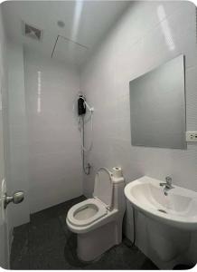 a bathroom with a toilet and a sink at Stay Inn Apartelle in Roxas City