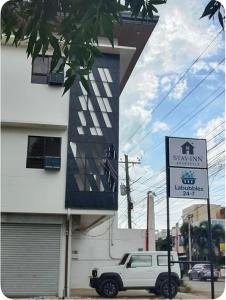 a white truck parked in front of a building at Stay Inn Apartelle in Roxas City +11 photos