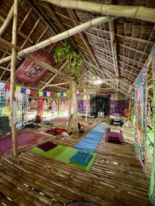 a large room with many different colored mats at Tribal Huts Community in Malapascua Island