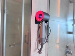 a red door knocker is attached to a wall at Vela Ha Van's House Ha Long in Ha Long +21 photos