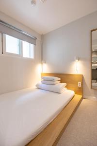 Postel nebo postele na pokoji v ubytování Pipe Hostel Myeongdong
