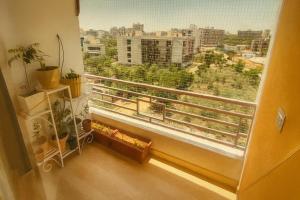 a window with a view of a city at VVIP Address Homestay Jagatpura Jaipur Luxury Stay in Jaipur