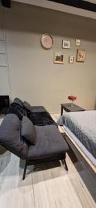 a couch sitting next to a bed in a room at Chic & Design Studio for 3 people in Thonon-les-Bains