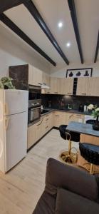 a large kitchen with white appliances and a table at Chic & Design Studio for 3 people in Thonon-les-Bains