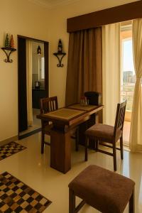 a dining room with a wooden table and chairs at VVIP Address Homestay Jagatpura Jaipur Luxury Stay in Jaipur +28 photos