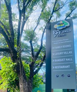 a sign for a park next to a tree at Avasta Resort Wijaya Leisure in Anuradhapura