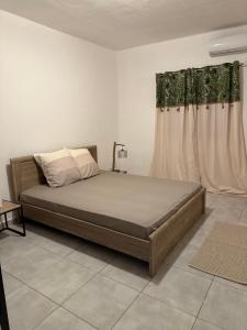 Un dormitorio con una cama y una ventana en Charmant appartement, en Kani Keli