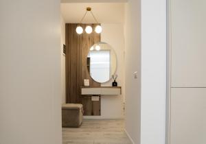 a bathroom with a sink and a mirror at GM Residence Deluxe 1&2 bedrooms in Suceava +15 photos