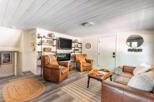 a living room with a couch and chairs and a tv at Uptown 1 Bedroom Flat Near the Boise Train Depot in Boise