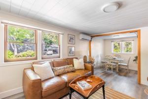 a living room with a couch and a table at Uptown 1 Bedroom Flat Near the Boise Train Depot in Boise