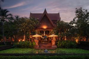 a house with stairs and umbrellas in front of it at Anantara Hua Hin Resort in Hua Hin +97 photos