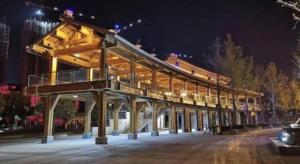 a large building with a deck at night at City Comfort Inn Deyang Shifang Yonghu Park in Shifang