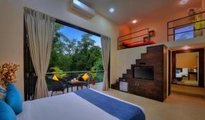 a bedroom with a bed and a large window at Foxoso Sonnet, Anjuna Goa in Anjuna