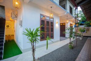 a house with plants in front of it at The Mud Crab 80 in Ahangama