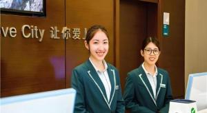 two young women sitting in front of a elevator at City Comfort Inn Wuzhou Bus Station in Wuzhou