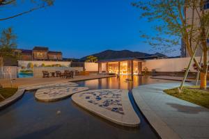 a house with a swimming pool at night at Huazhu Xiangshan Tongchen Courtyard in Xiangshan