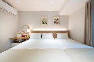 Ένα ή περισσότερα κρεβάτια σε δωμάτιο στο Hanadays Jongno-Gwanghwamun