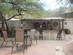 a group of chairs and tables in a patio at El Garaje Hostal in Taganga
