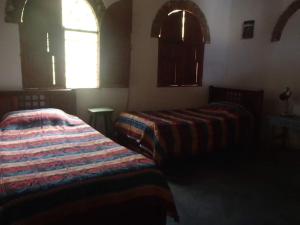 Postel nebo postele na pokoji v ubytování El Garaje Hostal