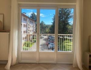 a sliding glass door with a view of a parking lot at Charming 2-room apartment, Grand Annecy in Meythet