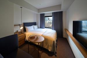 a hotel room with a bed and a table and a television at Hotel Resol Stay Akihabara in Tokyo +153 photos