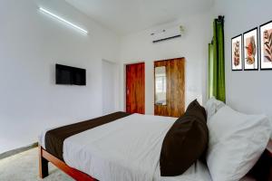 Ένα ή περισσότερα κρεβάτια σε δωμάτιο στο Hotel O Muthalipalayam Bus Stand Coimbatore Formerly Haven Stays