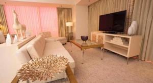 a living room with a couch and a television at Ahern Hotel and Event Center in Las Vegas