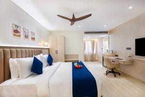 a bedroom with a large bed with a desk and a plane at Regenta Z Sunrise Gachibowli, Hyderabad in Kondapur +62 photos