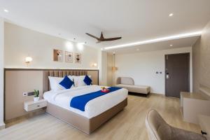 a bedroom with a king sized bed in a room at Regenta Z Sunrise Gachibowli, Hyderabad in Kondapur