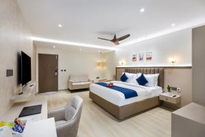 a bedroom with a king sized bed and a living room at Regenta Z Sunrise Gachibowli, Hyderabad in Kondapur