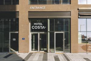 an entrance to a hotel costx building with revolving doors at Hotel Costa Geobukseom in Siheung
