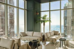 a living room filled with furniture and a large window at Hotel Costa Geobukseom in Siheung