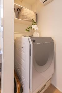 a white washer and dryer in a room at DUA 神楽坂Shinjuku area,train 3 mins,waseda,Kagurazaka in Tokyo