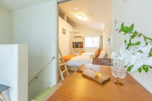 a living room with a table and a bed at DUA 神楽坂Shinjuku area,train 3 mins,waseda,Kagurazaka in Tokyo