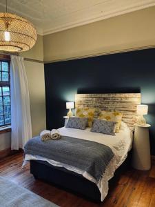 a bedroom with a large bed and a blue wall at Splash 9 in Trompsburg +17 photos