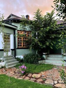 a house with a tree in front of it at Splash 9 in Trompsburg