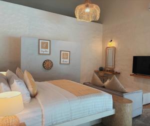 a bedroom with a large bed and a tv at Tropical Garden Luxury Villa, Koh Phangan in Thong Sala