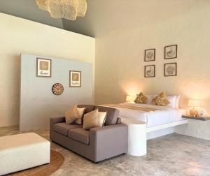 a bedroom with a large bed and a couch at Tropical Garden Luxury Villa, Koh Phangan in Thong Sala +17 photos