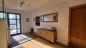 a room with a dresser and a mirror and a door at Quartier Levi in Oberhausen