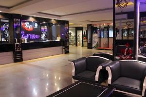 a lobby with two chairs and a large screen at Balai View Hotel in Tanjung Balai Karimun