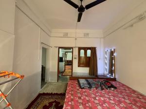 a room with a bed in the middle of a room at The Indoor Retreat in Siliguri