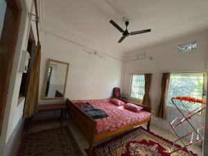 a bedroom with a bed and a ceiling fan at The Indoor Retreat in Siliguri