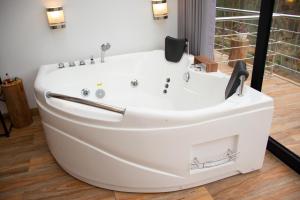 a white bath tub in a bathroom with a window at Xaxa Lodge in Tarma +55 photos