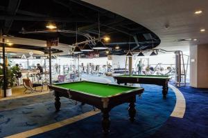 a room with two pool tables in a gym at Hua Xia Pearl Hotel in Nanzhuang