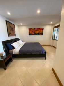 a bedroom with a bed and a table at Andaman Hill Pool Seaview in Patong Beach