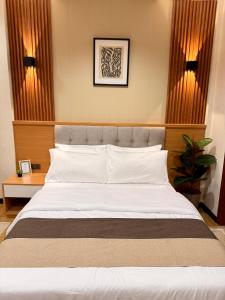 Ένα ή περισσότερα κρεβάτια σε δωμάτιο στο Lafontana Hometel