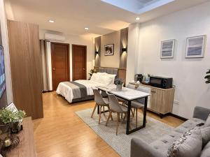 a hotel room with a bed and a table and chairs at Lafontana Hometel in Roxas City